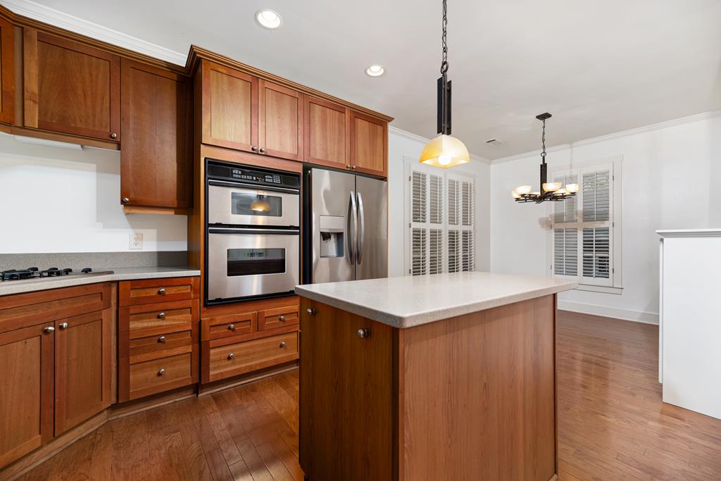 142 Maple Trace Pine Mountain, GA 31822 - Photo 13 of 61 a kitchen with kitchen island cabinets and refrigerator