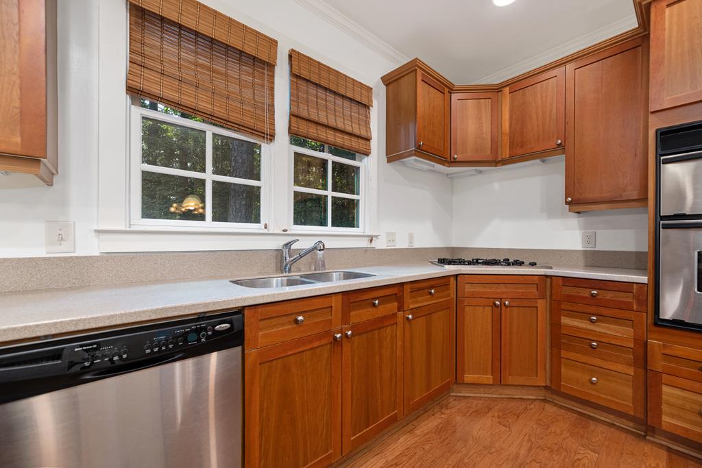 142 Maple Trace Pine Mountain, GA 31822 - Photo 15 of 61 a kitchen with stainless steel appliances granite countertop a sink stove and cabinets
