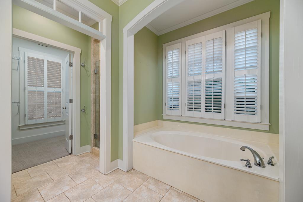 142 Maple Trace Pine Mountain, GA 31822 - Photo 19 of 61 a bathroom with a bathtub and next to a window