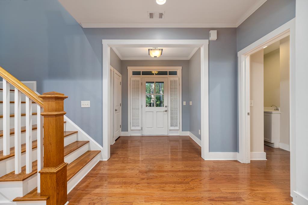 142 Maple Trace Pine Mountain, GA 31822 - Photo 10 of 61 a view of a hallway with wooden floor and staircase