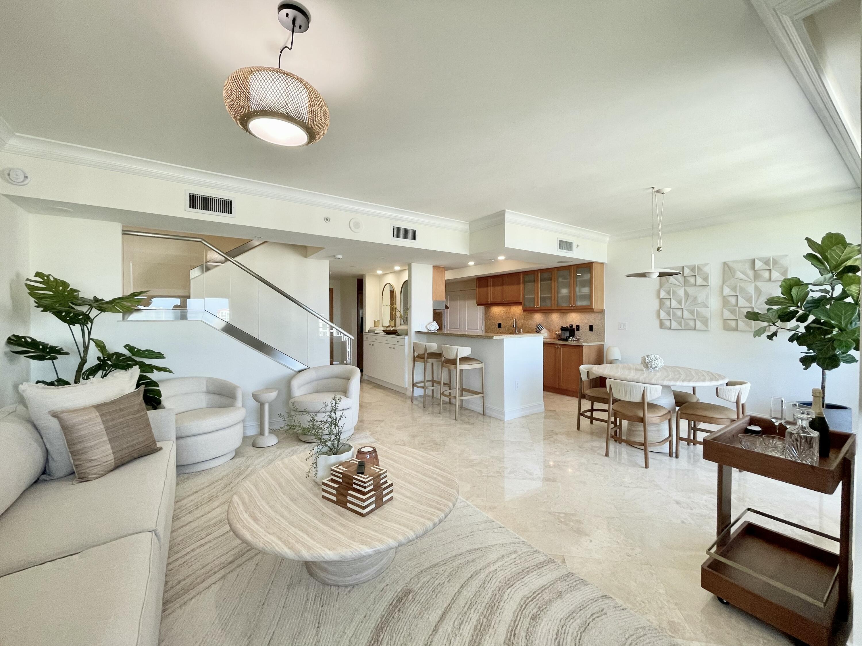 99 Southeast Mizner Boulevard, Unit PH5 Boca Raton, FL 33432 - Photo 11 of 48 a living room with furniture kitchen view and a large window