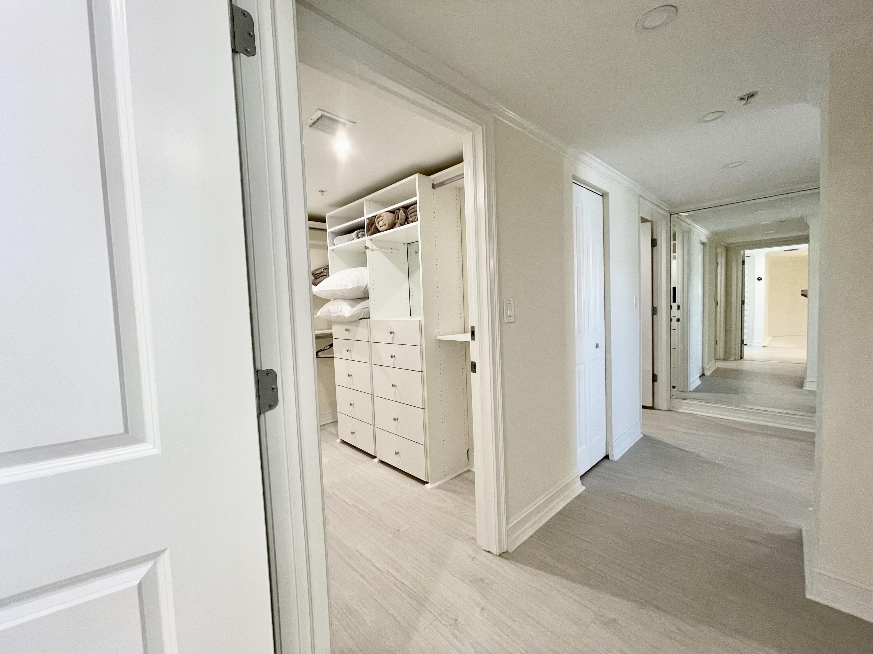 99 Southeast Mizner Boulevard, Unit PH5 Boca Raton, FL 33432 - Photo 13 of 48 wooden floor with white walls