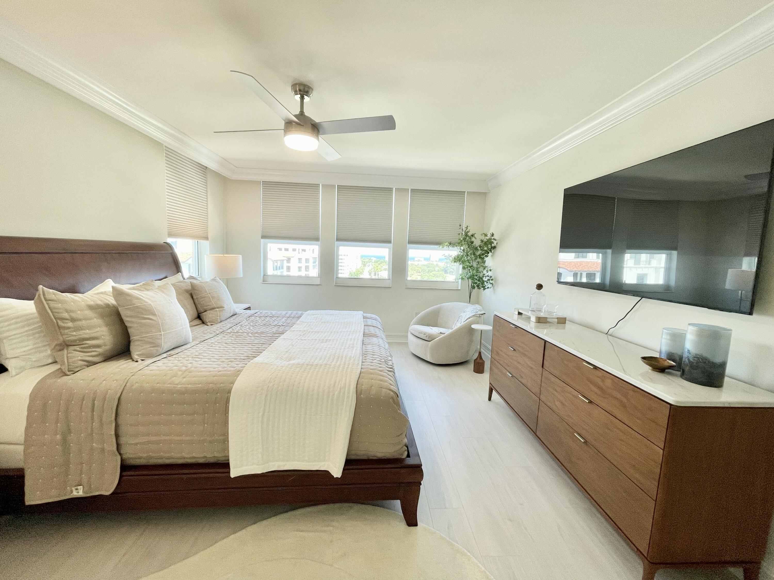 99 Southeast Mizner Boulevard, Unit PH5 Boca Raton, FL 33432 - Photo 16 of 48 a spacious bedroom with a bed and window