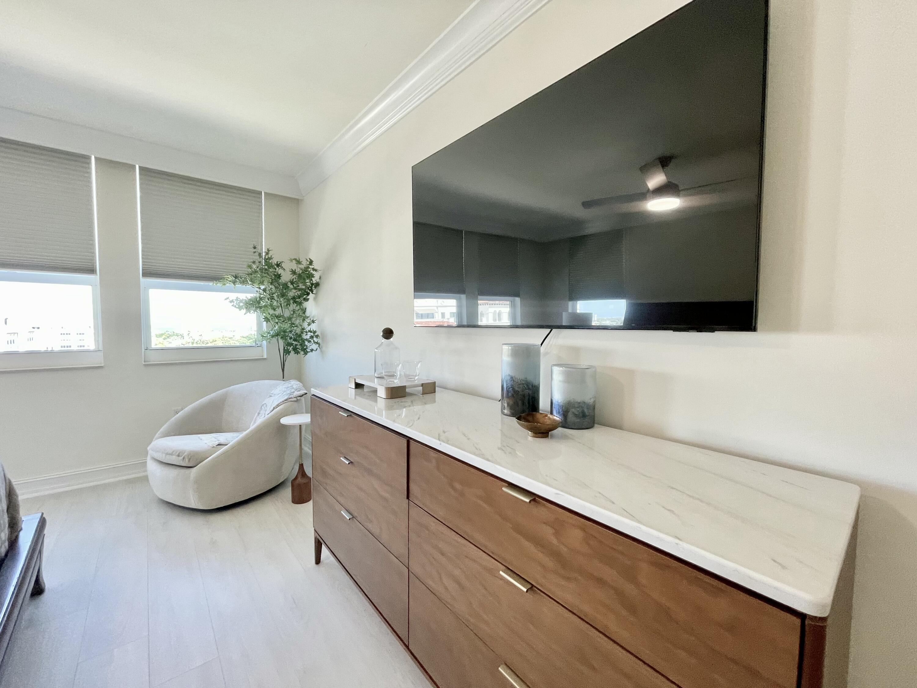 99 Southeast Mizner Boulevard, Unit PH5 Boca Raton, FL 33432 - Photo 17 of 48 a bathroom with a sink and a mirror