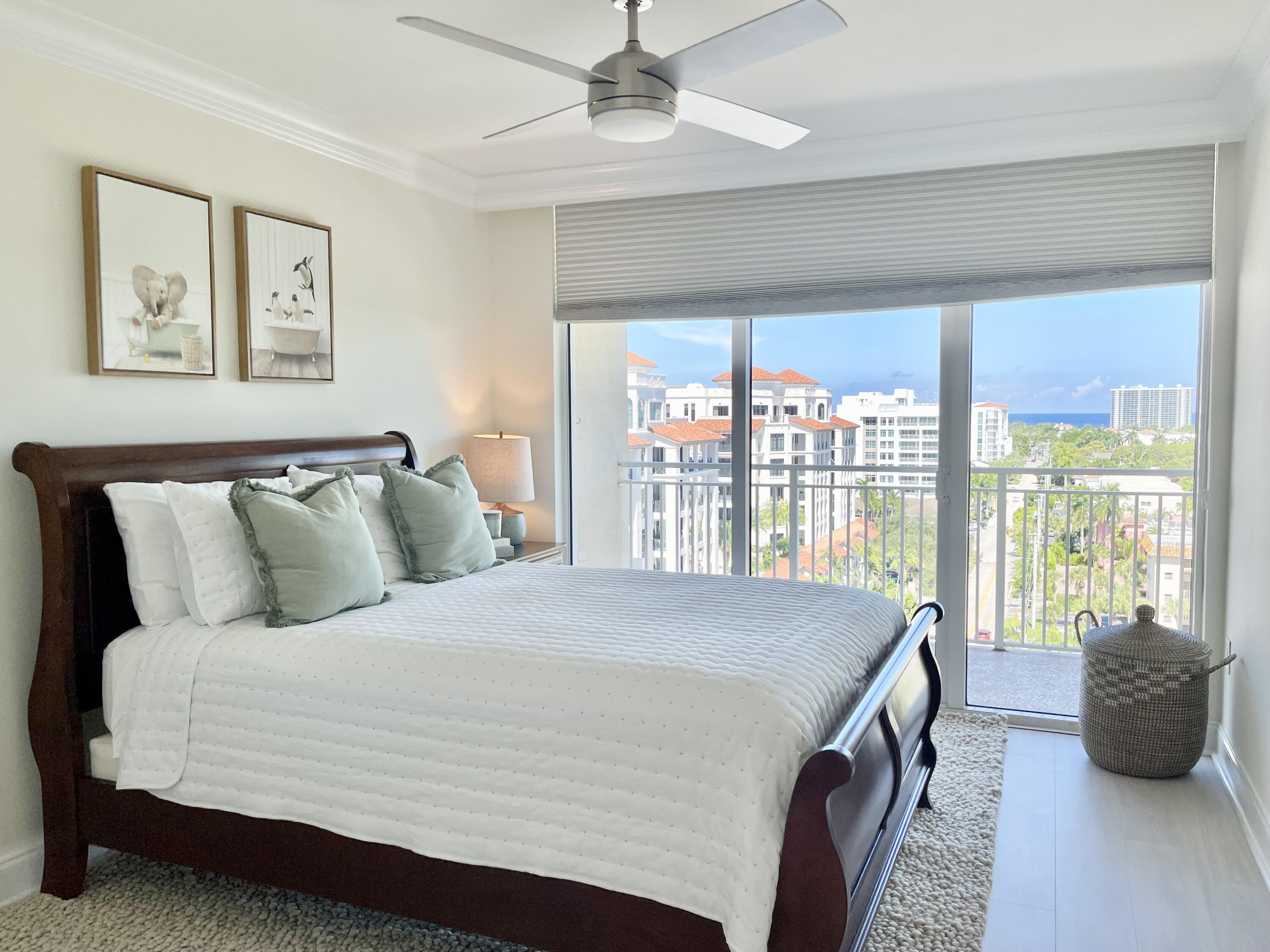 99 Southeast Mizner Boulevard, Unit PH5 Boca Raton, FL 33432 - Photo 19 of 48 a bedroom with a large bed and a large window