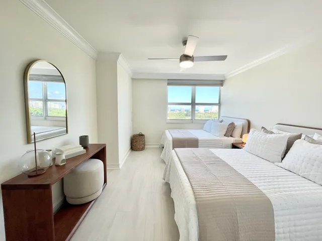 a bedroom with bed a couch and window