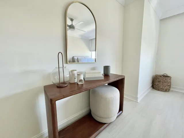 a bathroom with a granite countertop toilet a sink and a mirror