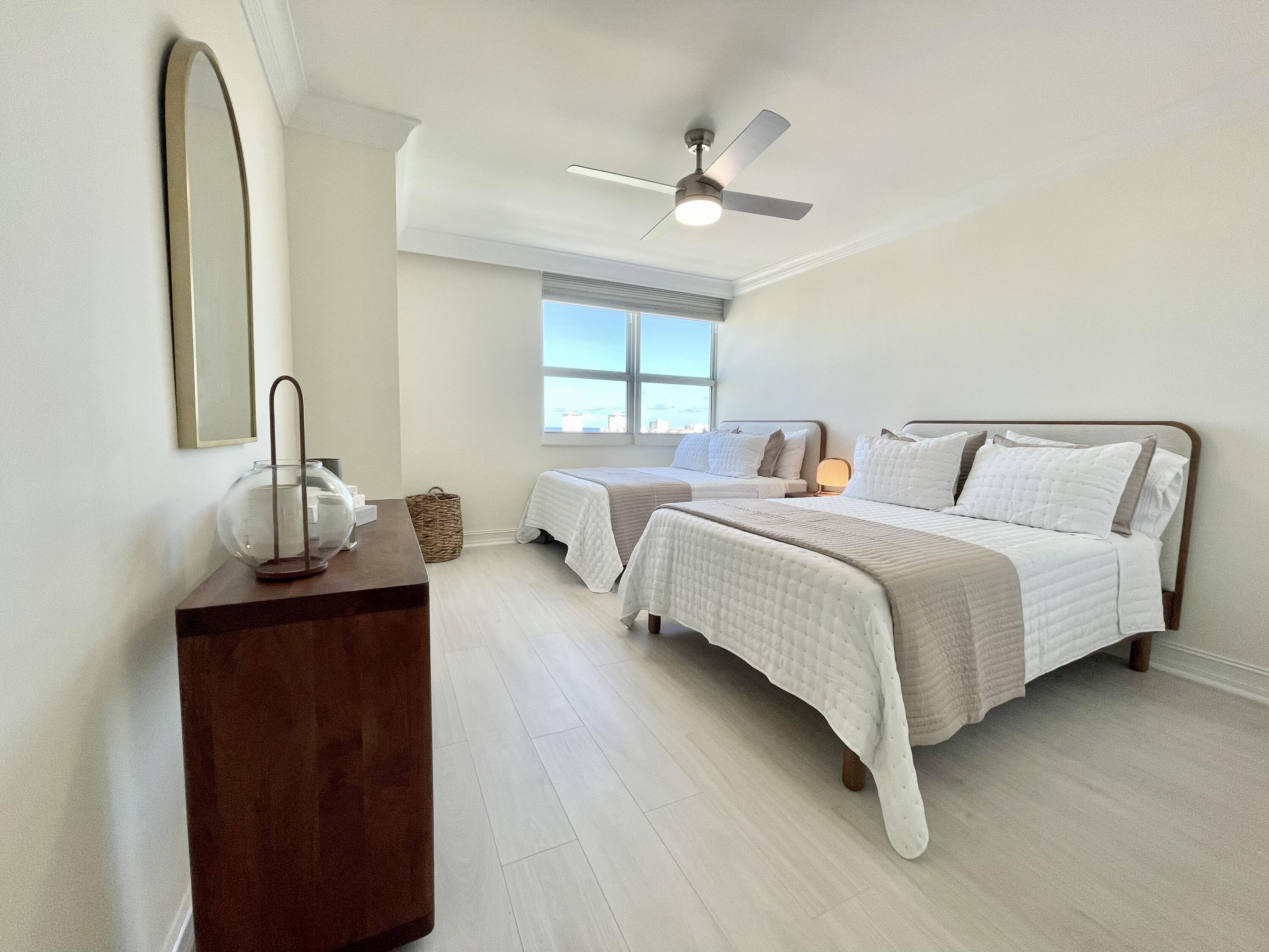 99 Southeast Mizner Boulevard, Unit PH5 Boca Raton, FL 33432 - Photo 25 of 48 a bedroom with a bed and a dresser