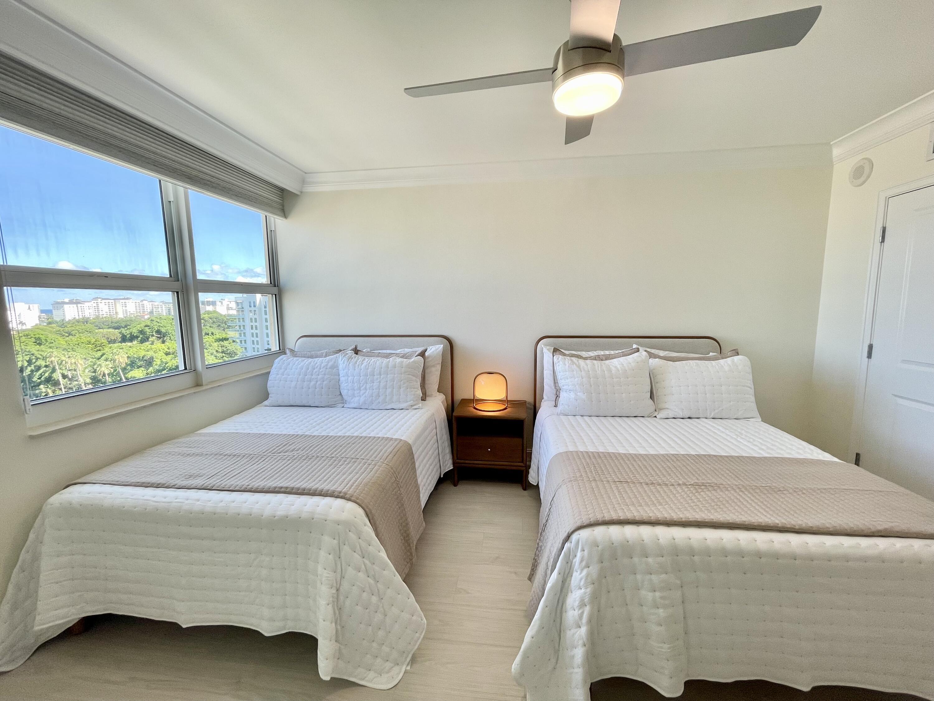 99 Southeast Mizner Boulevard, Unit PH5 Boca Raton, FL 33432 - Photo 26 of 48 a bedroom with a bed and a large window