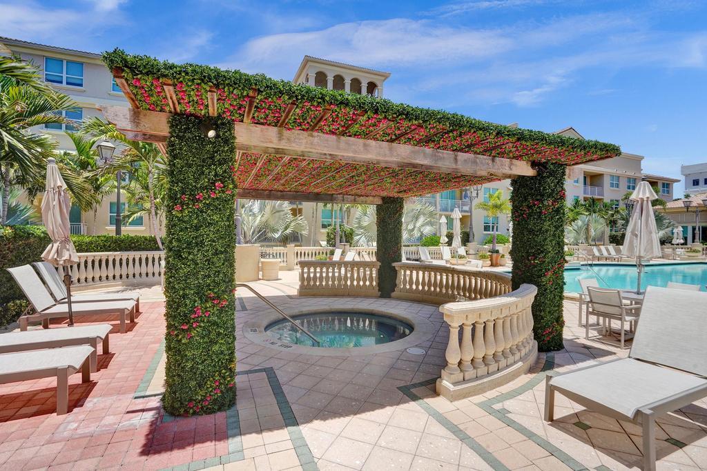 99 Southeast Mizner Boulevard, Unit PH5 Boca Raton, FL 33432 - Photo 34 of 48 a front view of a house with a garden and patio