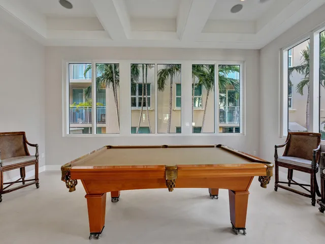 a room with furniture pool table and windows