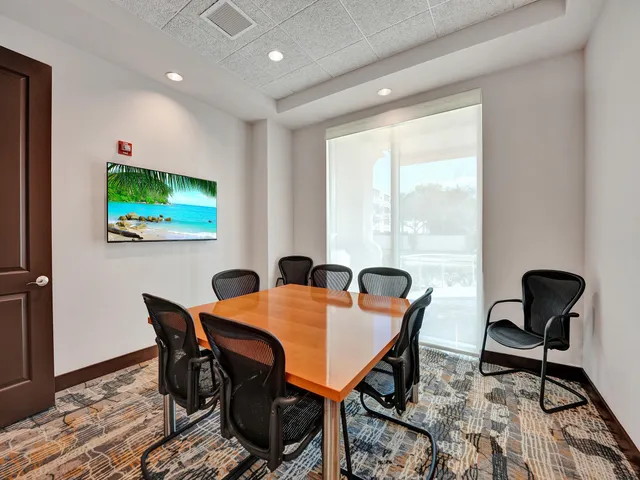 a view of a dining room with furniture and window