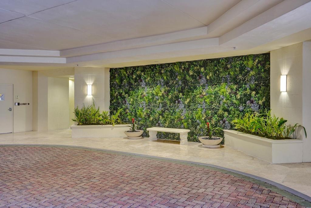99 Southeast Mizner Boulevard, Unit PH5 Boca Raton, FL 33432 - Photo 45 of 48 a view of a patio with plants and potted plants