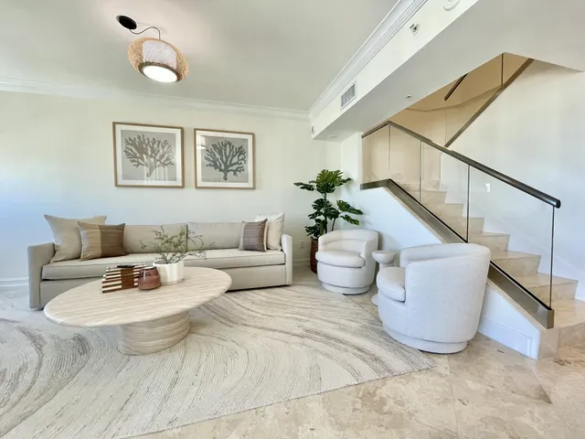 a living room with stainless steel appliances kitchen island granite countertop furniture and a large window