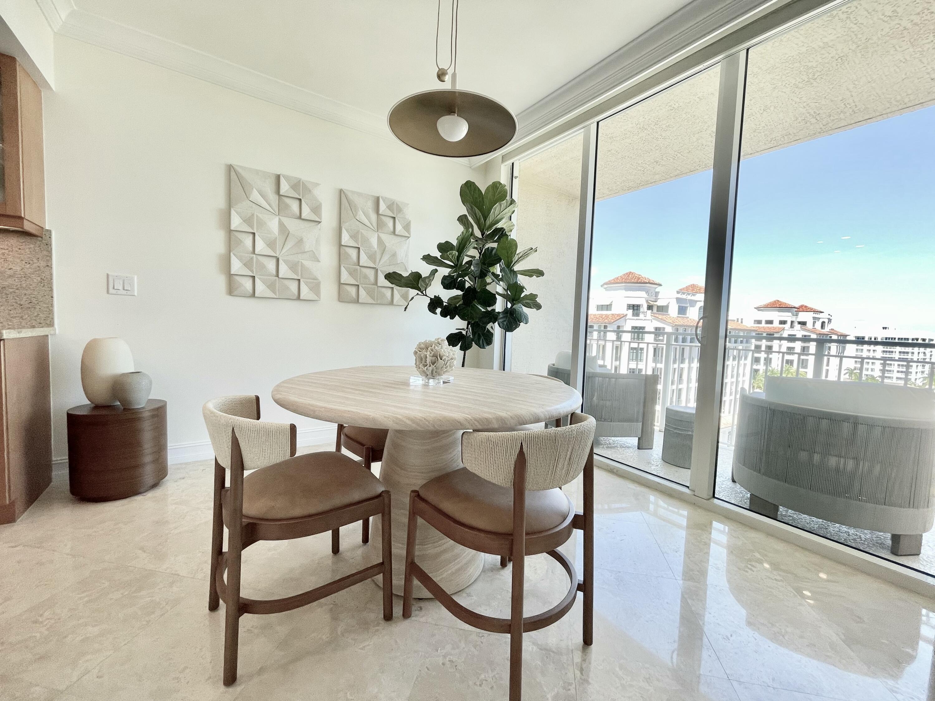 99 Southeast Mizner Boulevard, Unit PH5 Boca Raton, FL 33432 - Photo 6 of 48 a dining room with furniture and window
