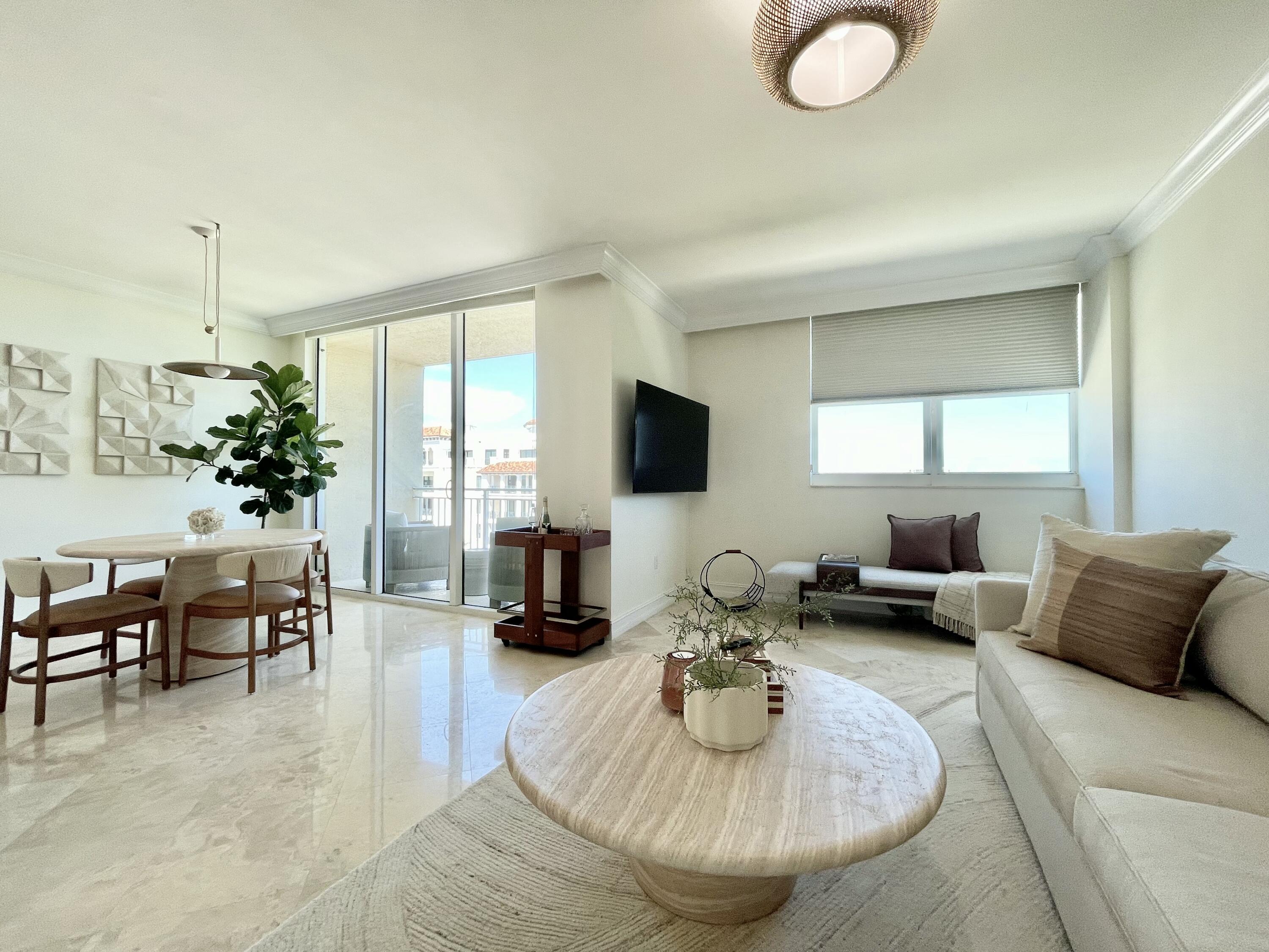 99 Southeast Mizner Boulevard, Unit PH5 Boca Raton, FL 33432 - Photo 7 of 48 a living room with furniture and a flat screen tv