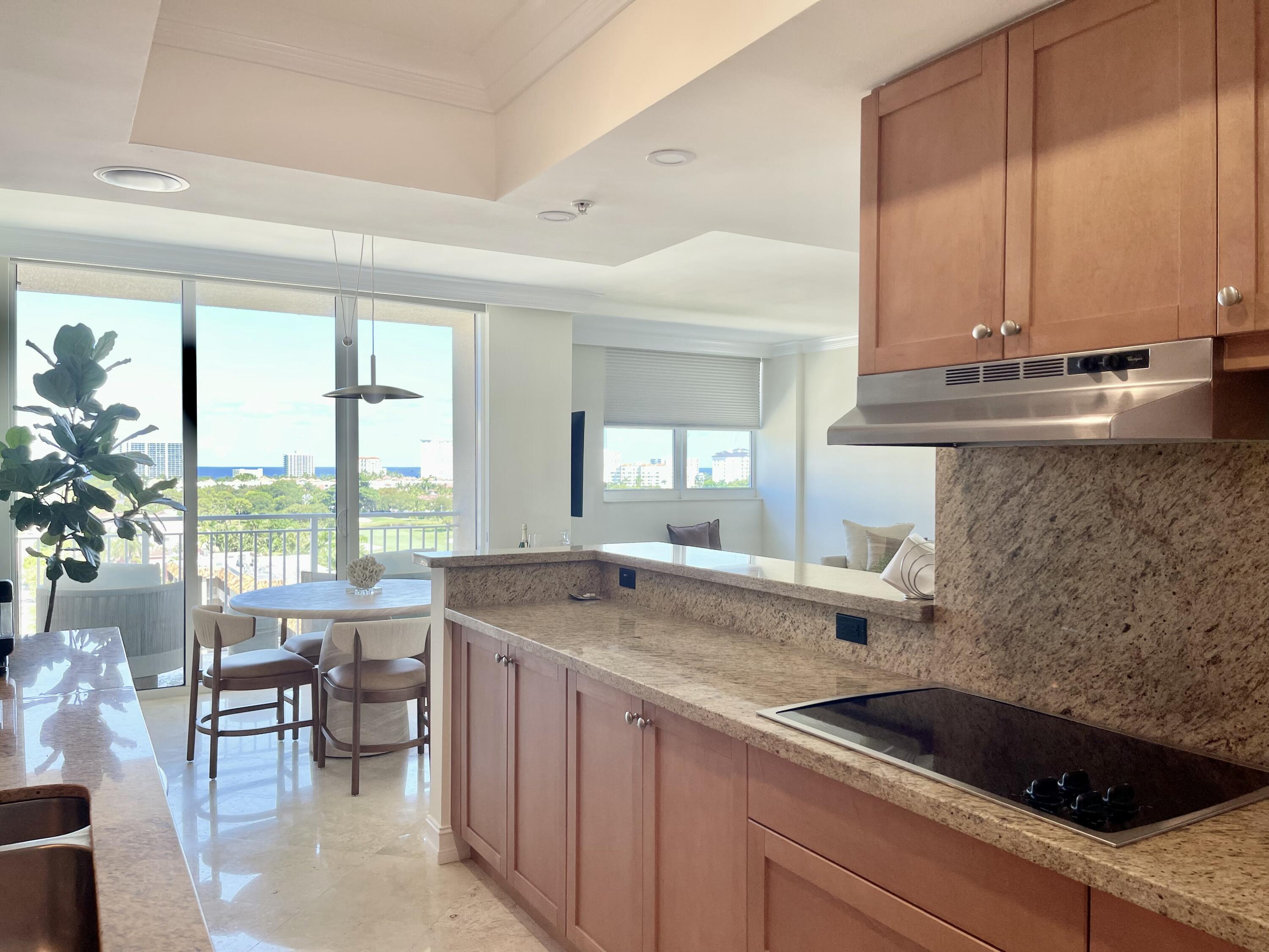 99 Southeast Mizner Boulevard, Unit PH5 Boca Raton, FL 33432 - Photo 9 of 48 a kitchen with a sink and large window