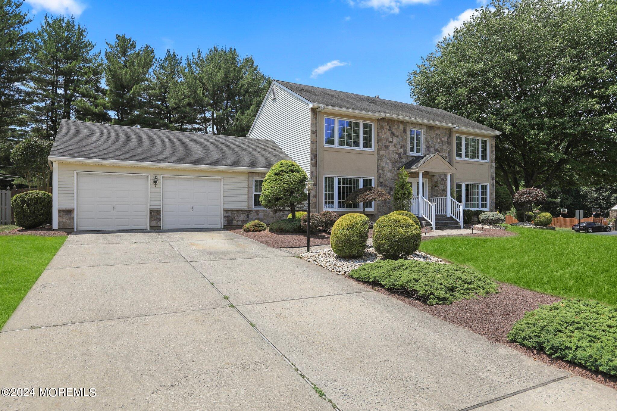 2 Cedar Court Marlboro, NJ 07746 - Photo 2 of 46 a front view of a house with a yard and garage