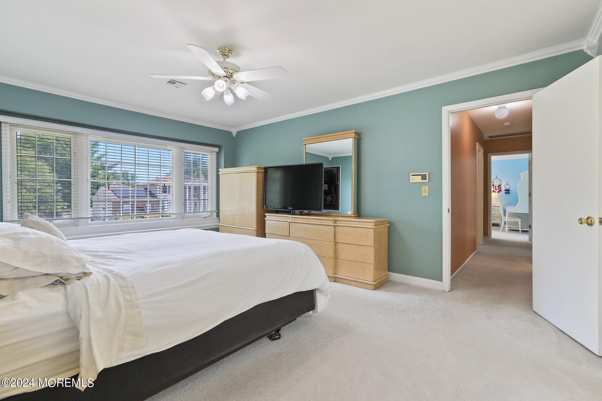 2 Cedar Court Marlboro, NJ 07746 - Photo 28 of 46 a bedroom with a large bed and a flat tv screen on dresser
