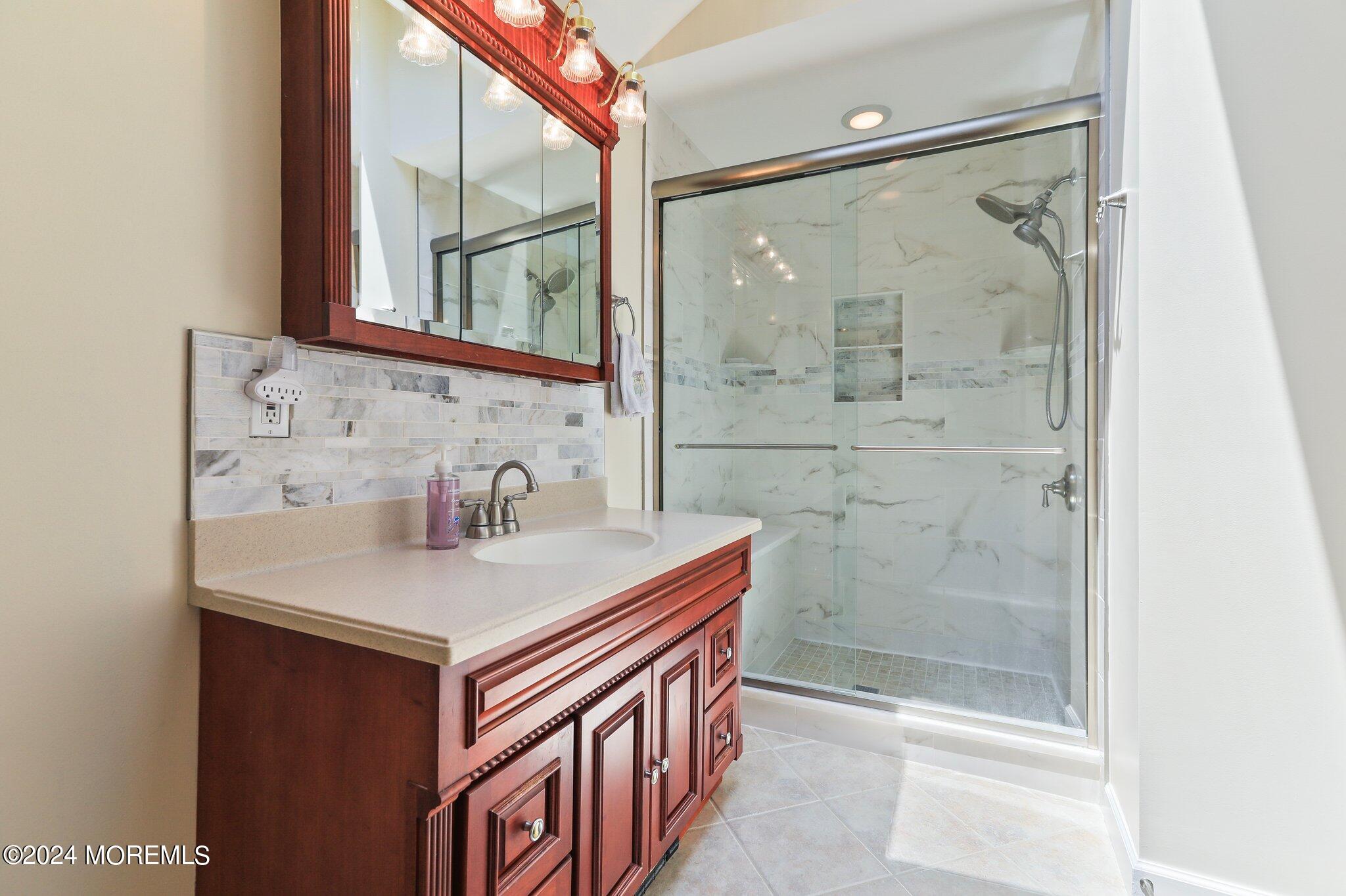 2 Cedar Court Marlboro, NJ 07746 - Photo 29 of 46 a bathroom with a sink a vanity and a shower