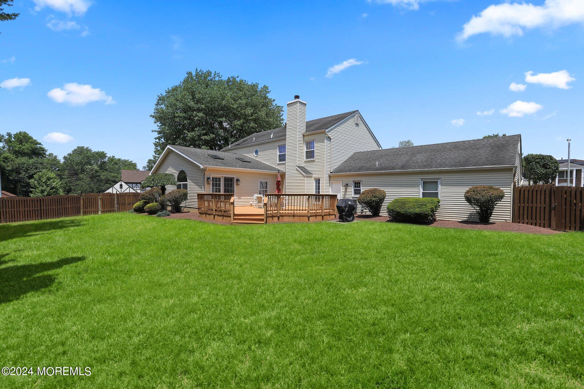 2 Cedar Court Marlboro, NJ 07746 - Photo 37 of 46 a view of a white house in front of a big yard with large trees