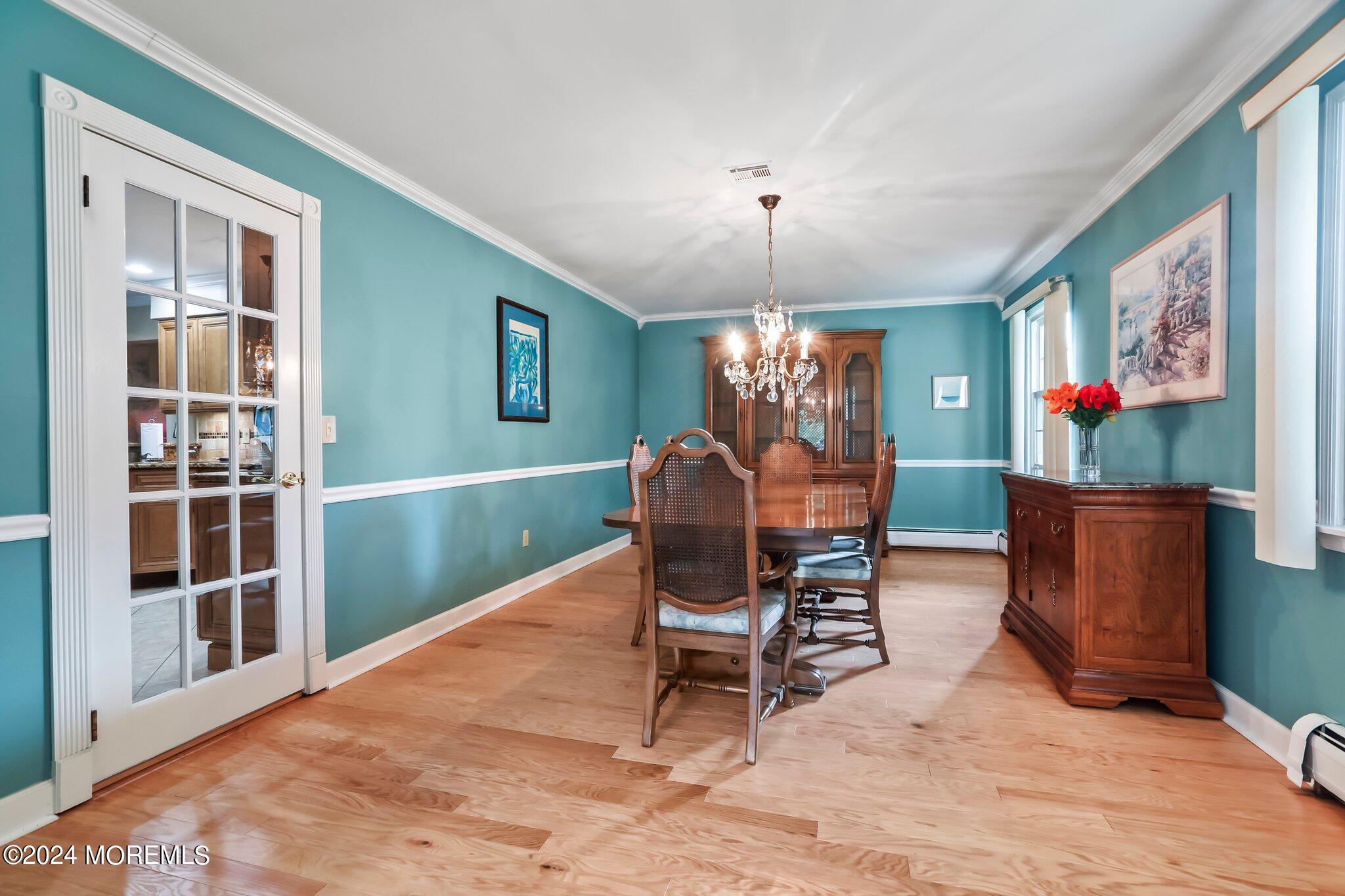 2 Cedar Court Marlboro, NJ 07746 - Photo 9 of 46 a dining room with furniture a floor to ceiling window and wooden floor