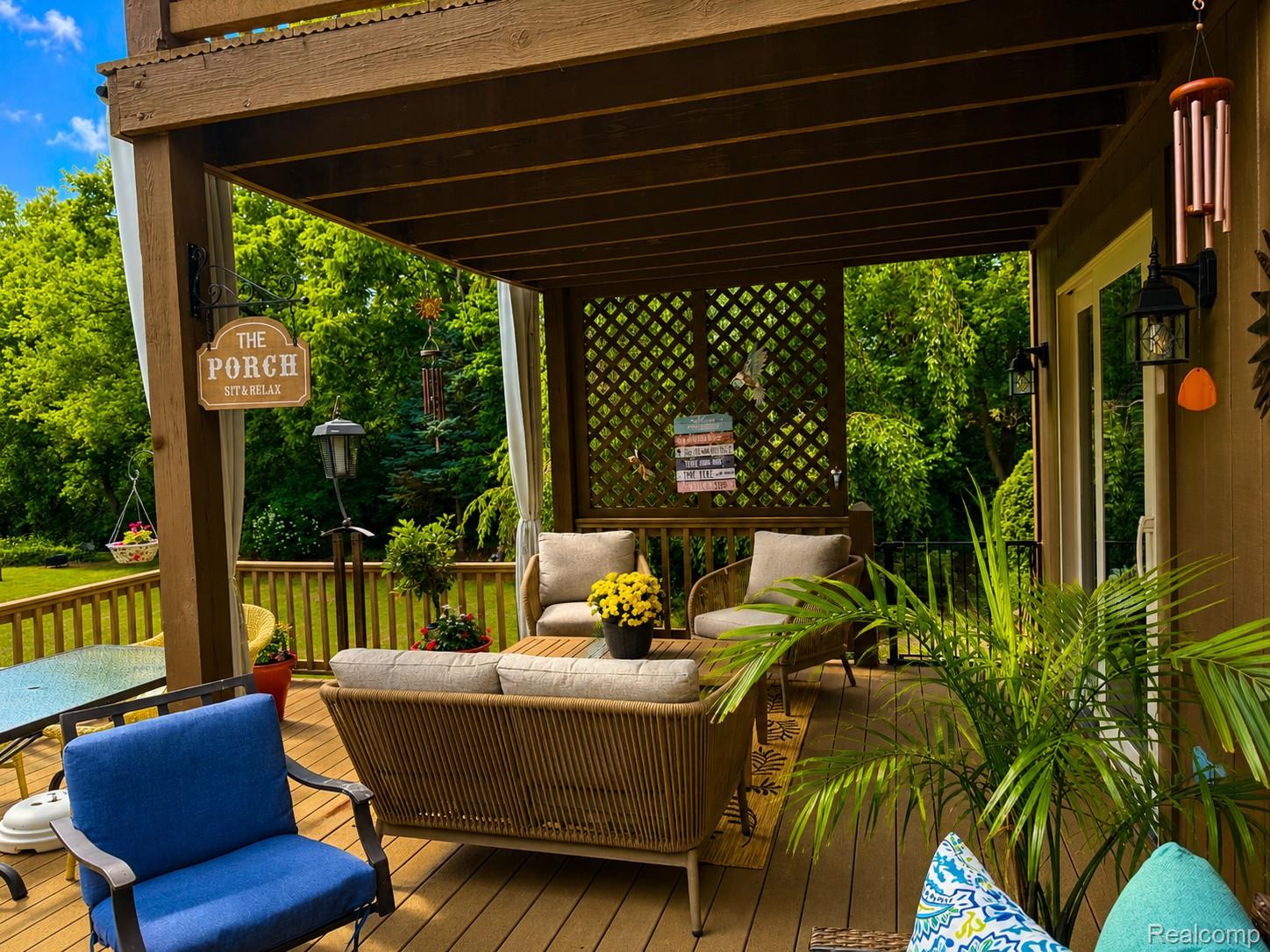 2495 North Custer Road Monroe, MI 48162 - Photo 32 of 44 Wood-finish multi-level deck featuring a covered patio area with lattice accents, outdoor lighting fixtures, and a sliding glass door entry to the interior