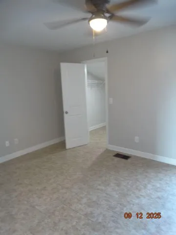 an empty room with a ceiling fan