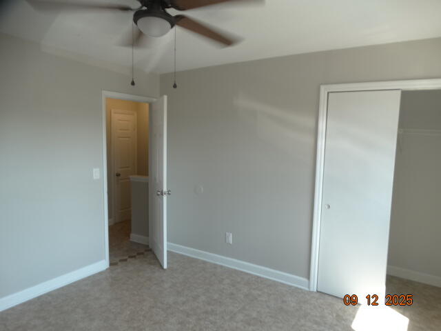 1325 Greendale Avenue, Unit 20 Fort Walton Beach, FL 32547 - Photo 24 of 30 an empty room with a ceiling fan and carpet
