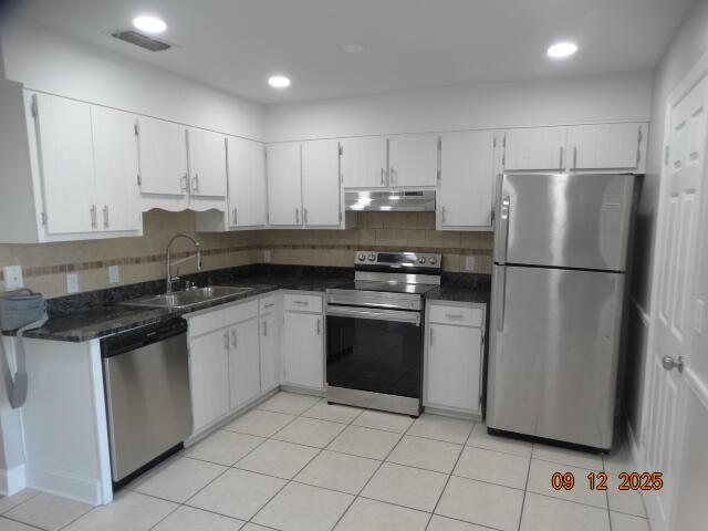 1325 Greendale Avenue, Unit 20 Fort Walton Beach, FL 32547 - Photo 6 of 30 a kitchen with granite countertop white cabinets and stainless steel appliances