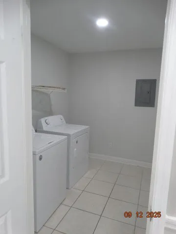 a utility room with cabinets washer and dryer