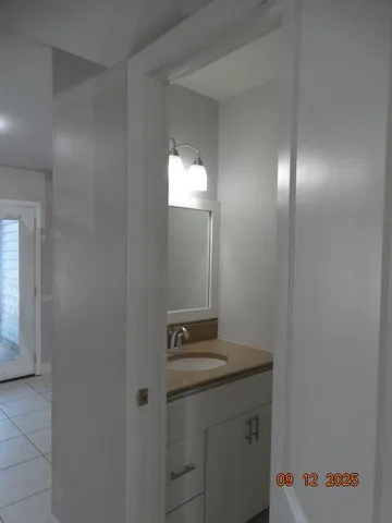a bathroom with a light fixture and a mirror