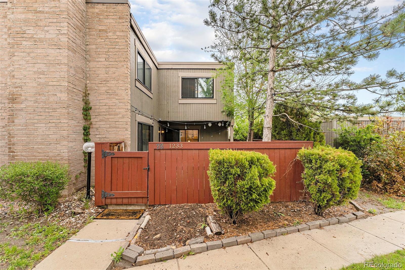 1233 South Yosemite Way, Unit 76 Denver, CO 80247 - Photo 1 of 20 a view of a back yard of the house