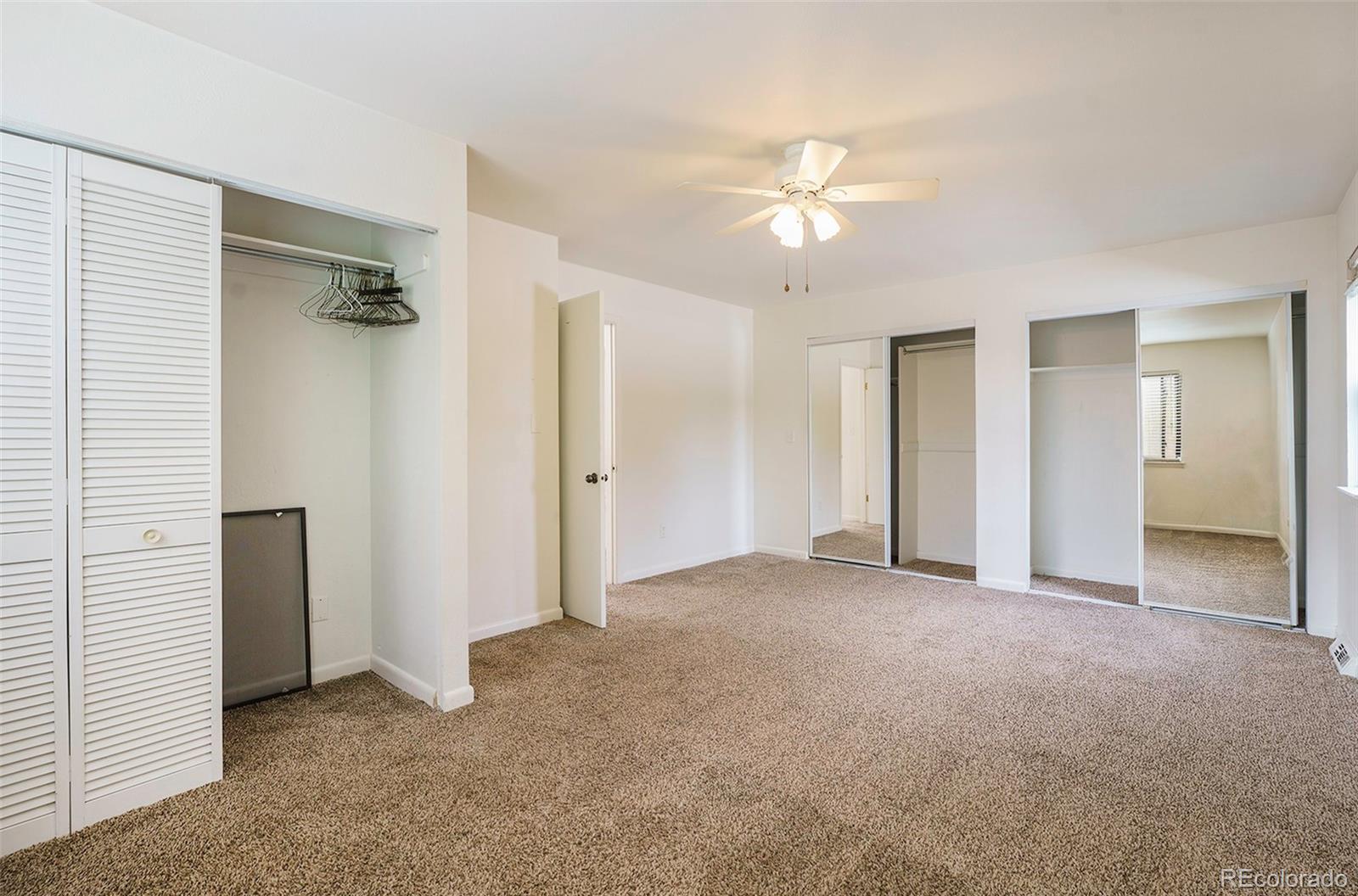 1233 South Yosemite Way, Unit 76 Denver, CO 80247 - Photo 11 of 20 an empty room with closet and a ceiling fan