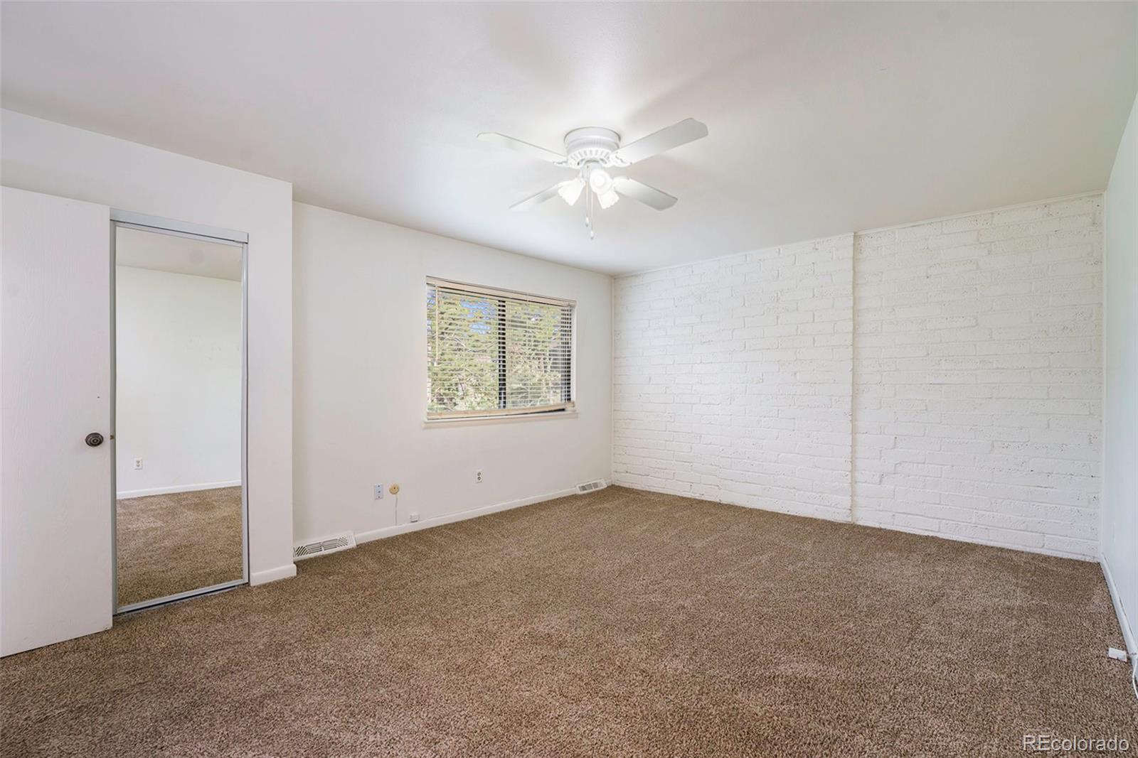 1233 South Yosemite Way, Unit 76 Denver, CO 80247 - Photo 14 of 20 an empty room with a fan & a window
