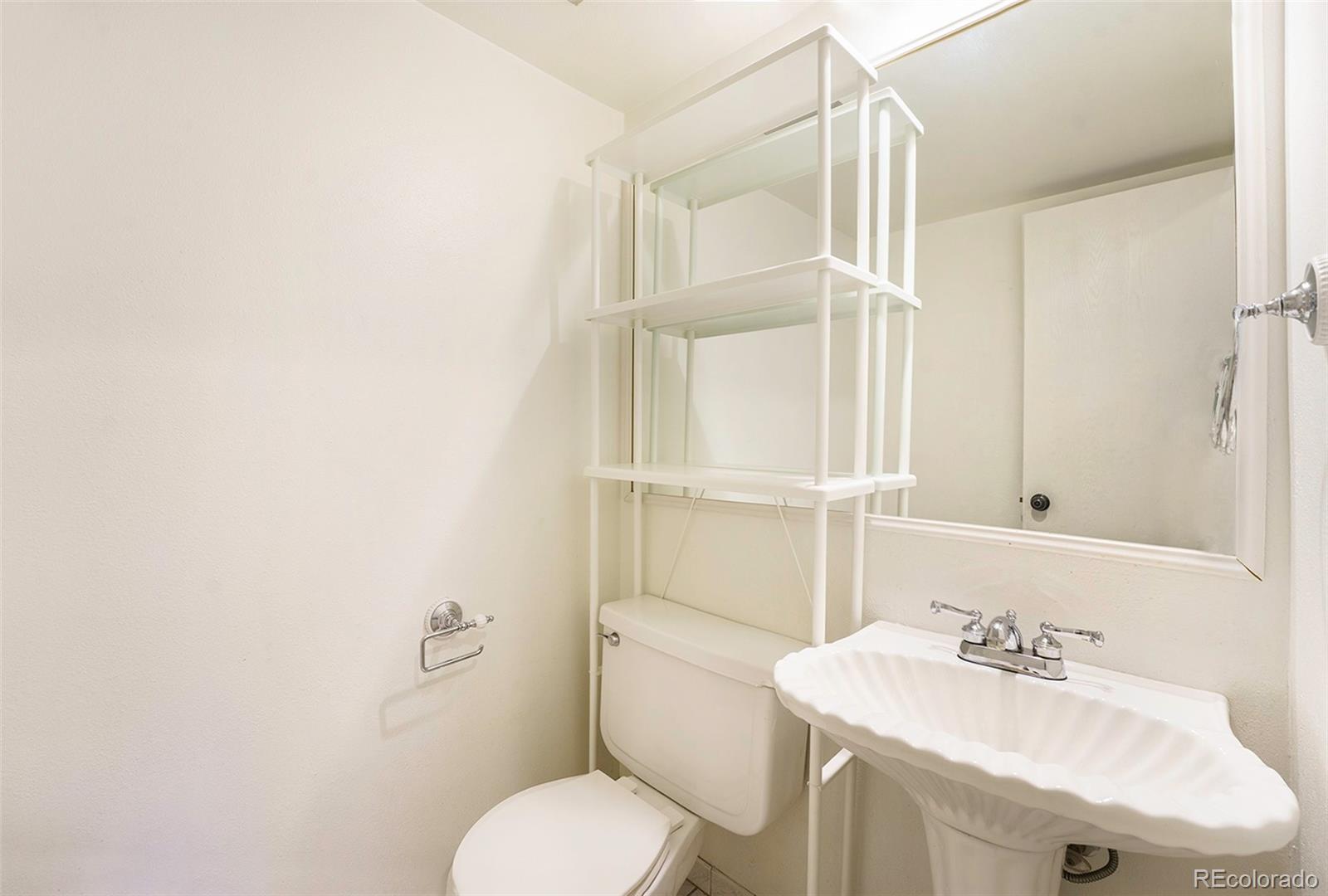 1233 South Yosemite Way, Unit 76 Denver, CO 80247 - Photo 15 of 20 a bathroom with a sink toilet and vanity