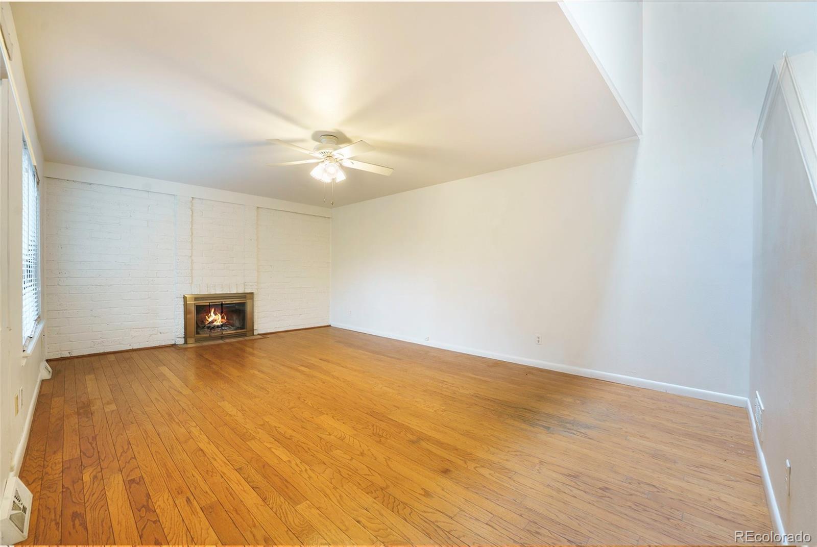 1233 South Yosemite Way, Unit 76 Denver, CO 80247 - Photo 2 of 20 wooden floor in an empty room