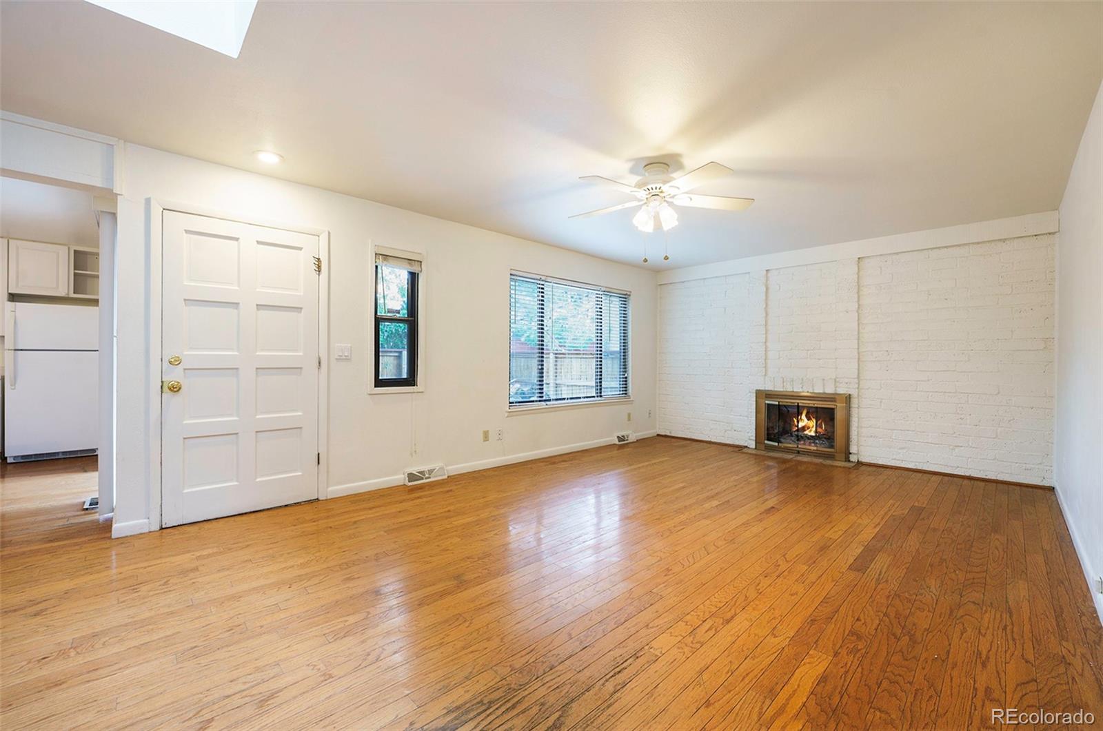1233 South Yosemite Way, Unit 76 Denver, CO 80247 - Photo 3 of 20 an empty room with windows and ceiling fan