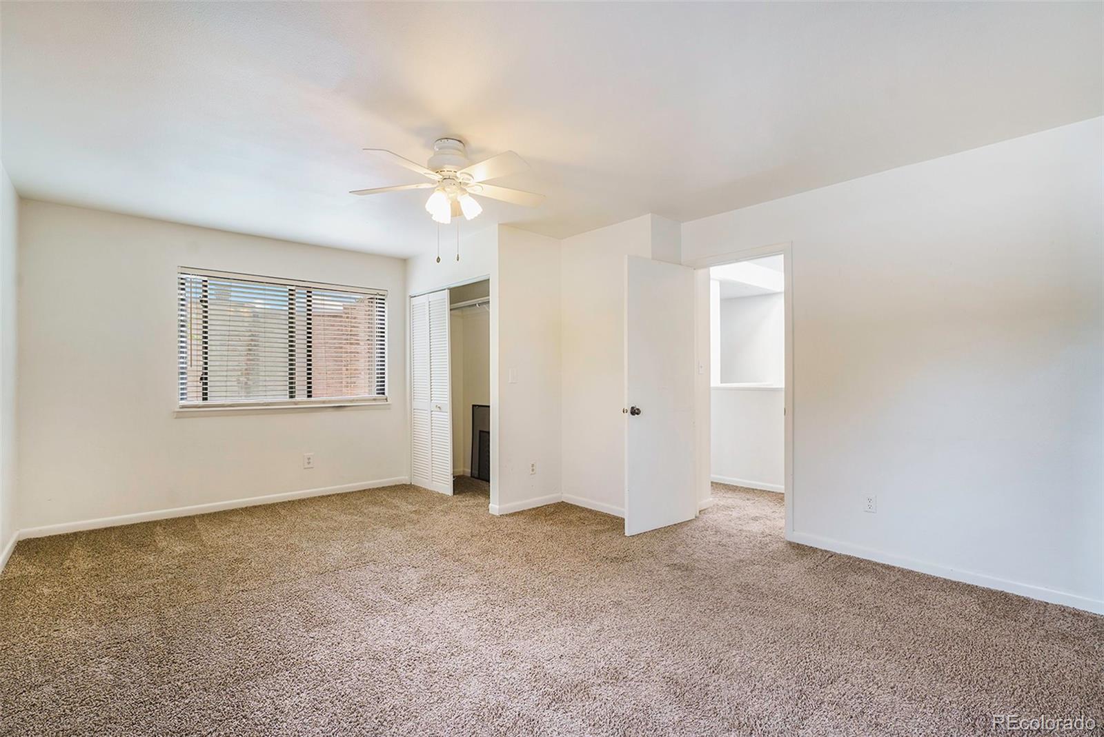 1233 South Yosemite Way, Unit 76 Denver, CO 80247 - Photo 10 of 20 a view of an empty room with a window