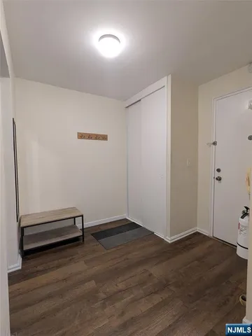 a view of a room with wooden floor