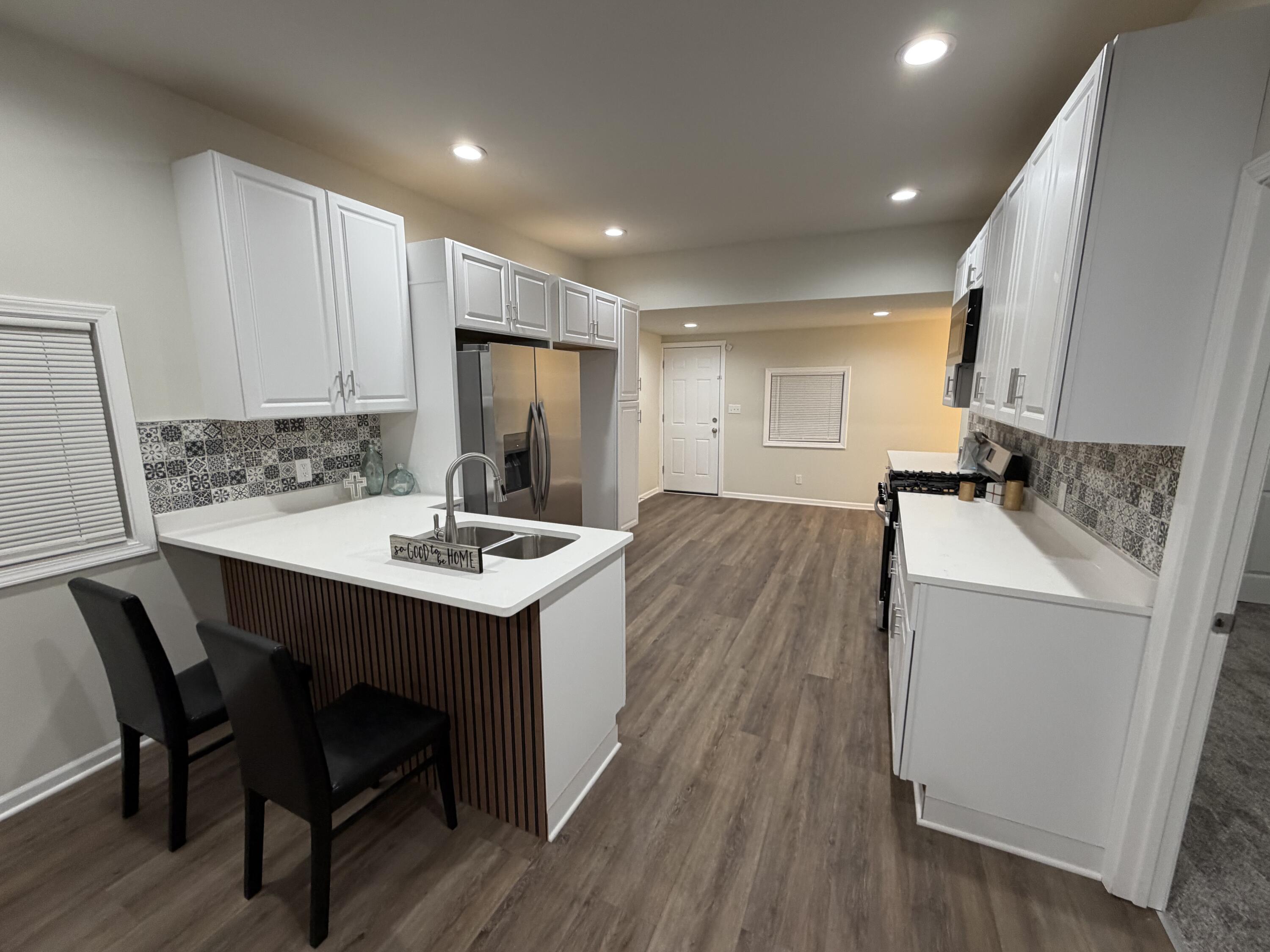 3744 Washington Street Gary, IN 46408 - Photo 2 of 25 a kitchen with a sink appliances and wooden floor