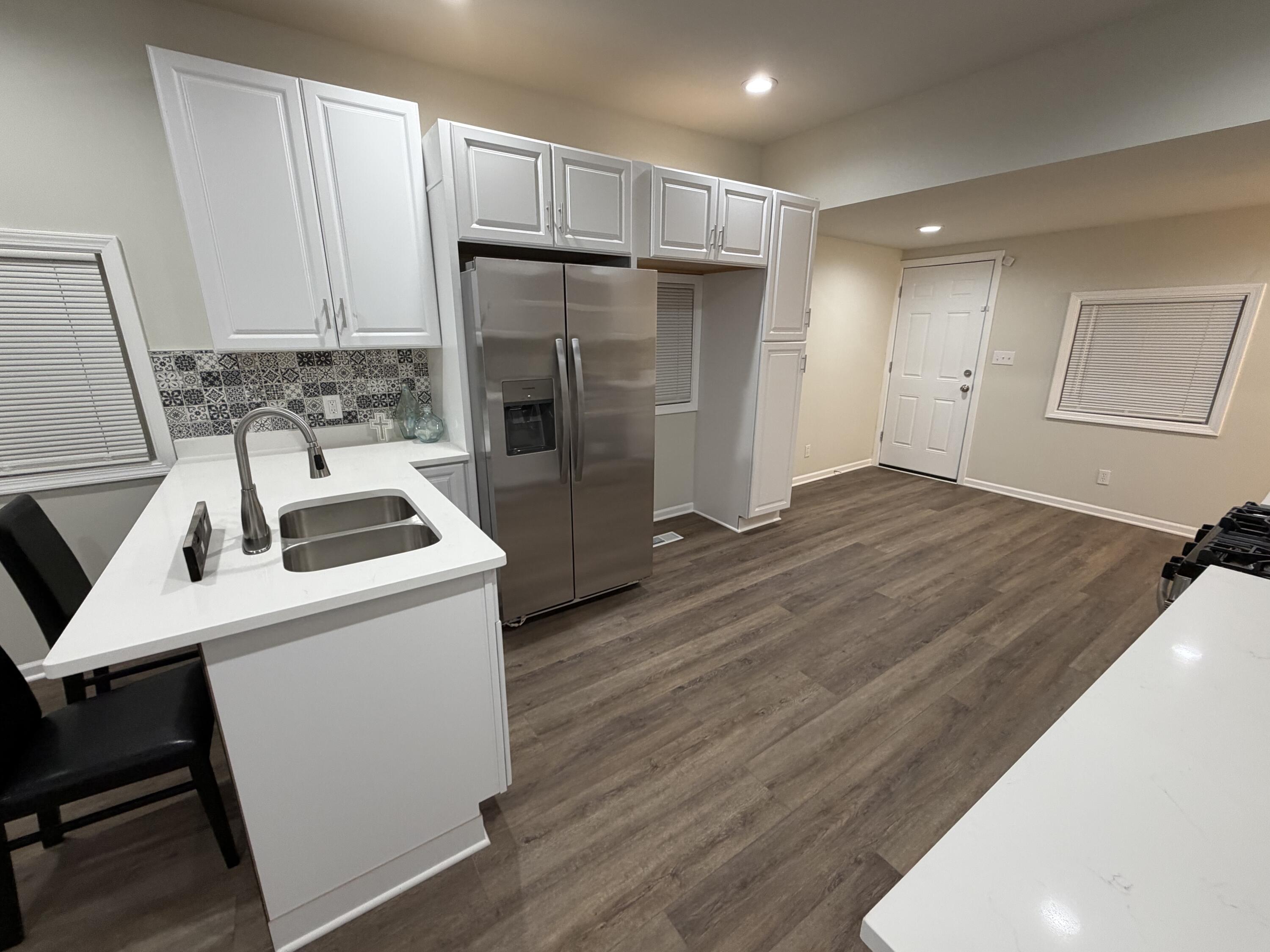 3744 Washington Street Gary, IN 46408 - Photo 3 of 25 a kitchen with a sink a refrigerator and cabinets