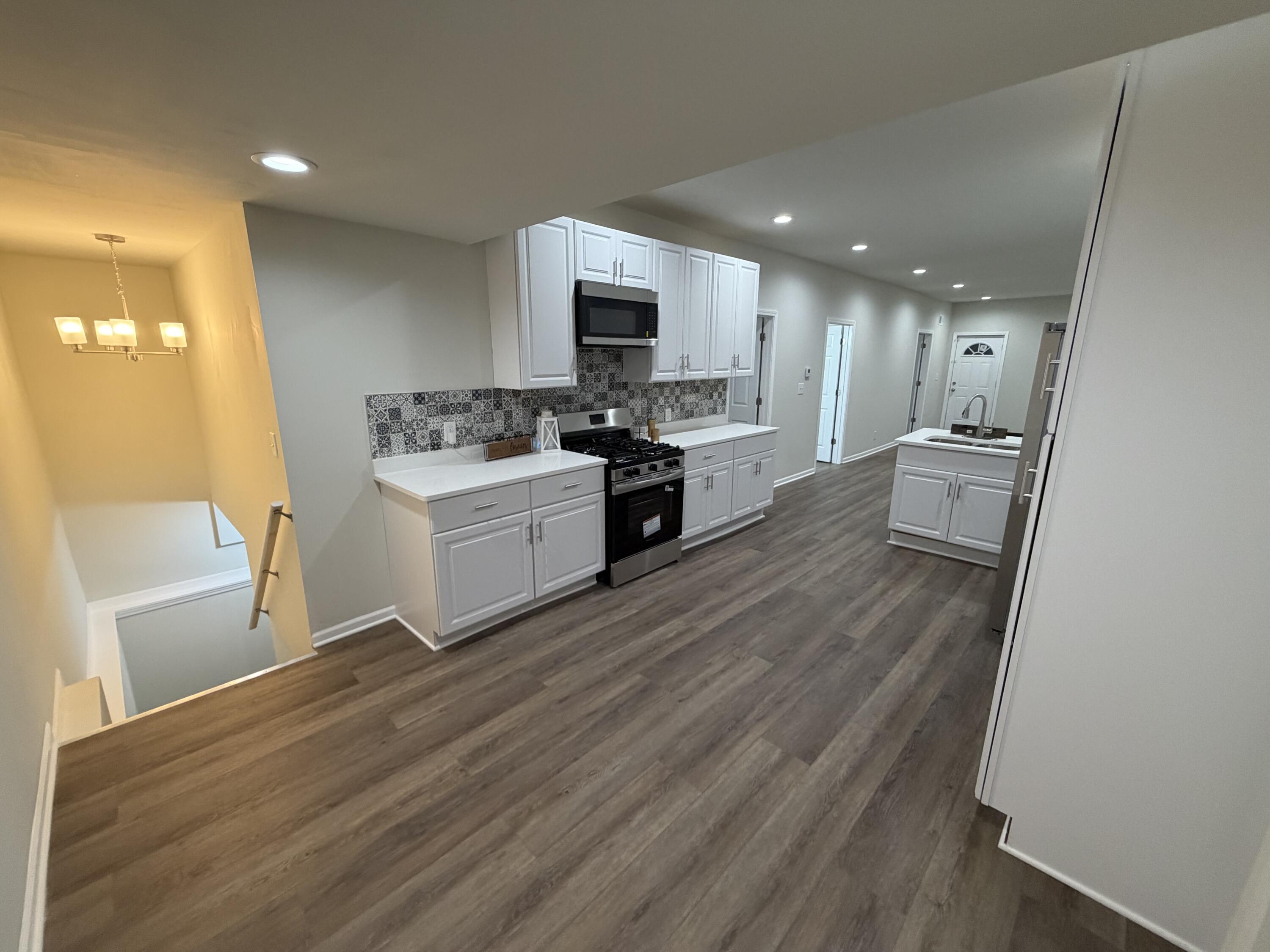 3744 Washington Street Gary, IN 46408 - Photo 4 of 25 a kitchen with a sink stainless steel appliances and cabinets