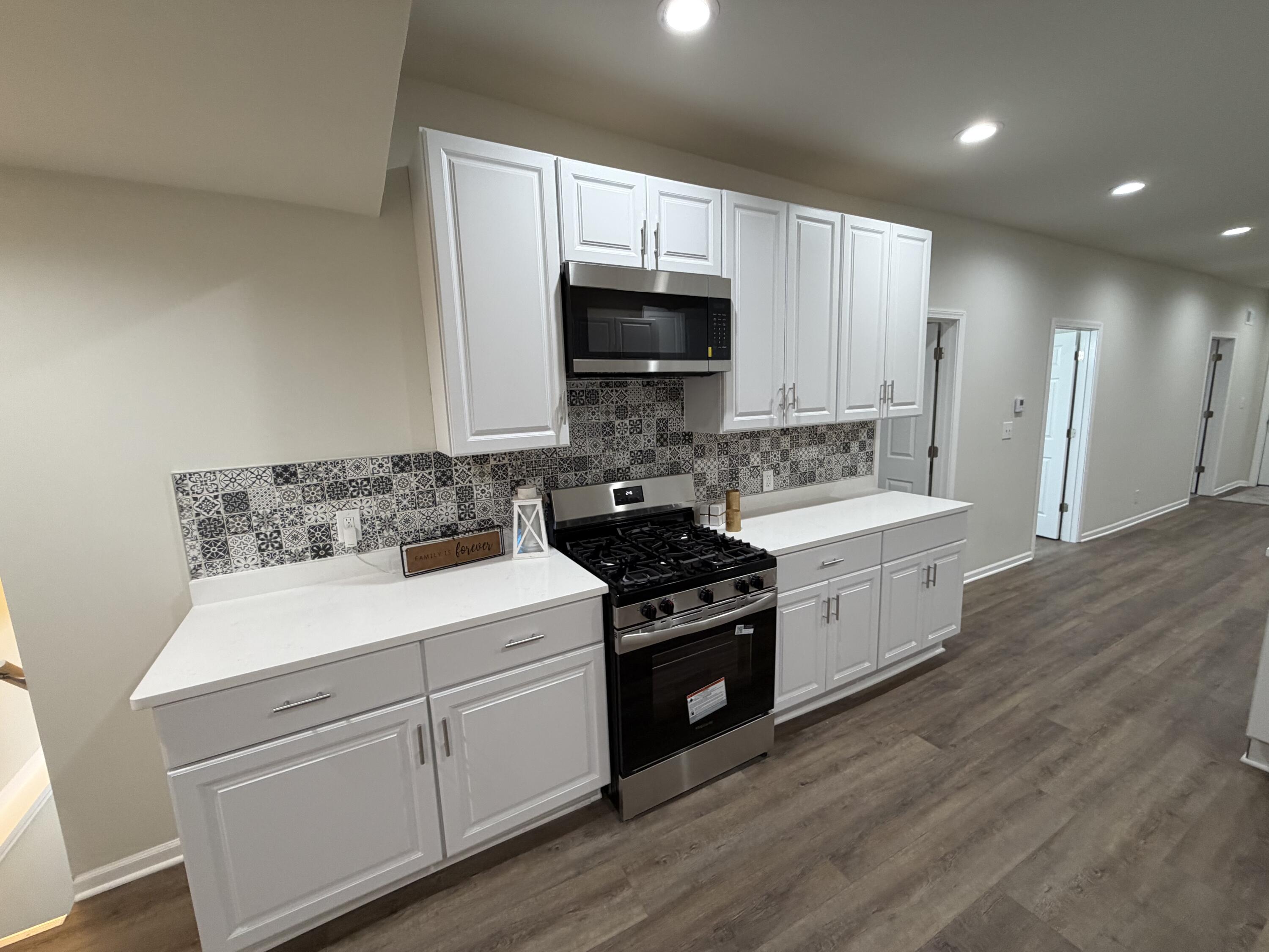 3744 Washington Street Gary, IN 46408 - Photo 5 of 25 a kitchen with stainless steel appliances granite countertop a stove a sink and a microwave