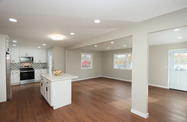 a kitchen with a sink and wooden floor