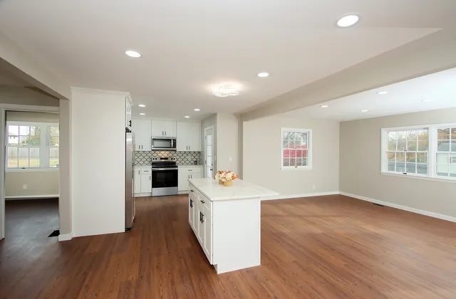 a view of a kitchen and wooden floor