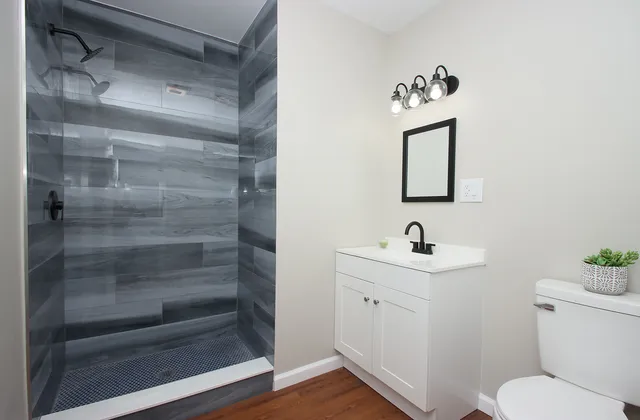 a bathroom with a toilet sink and shower