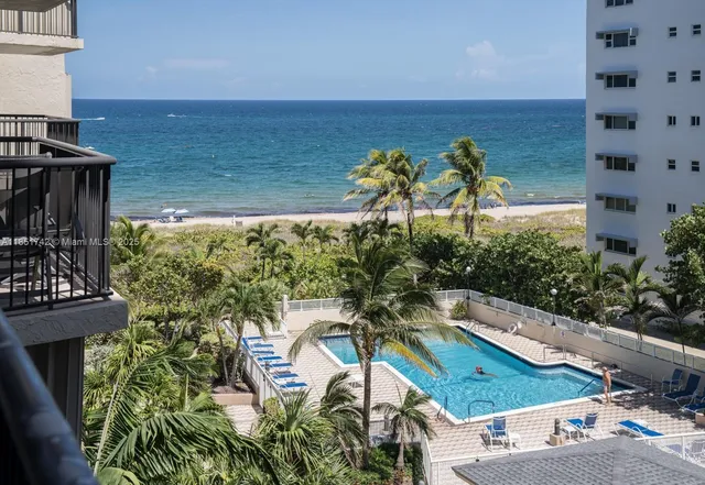 a view of a swimming pool with a yard