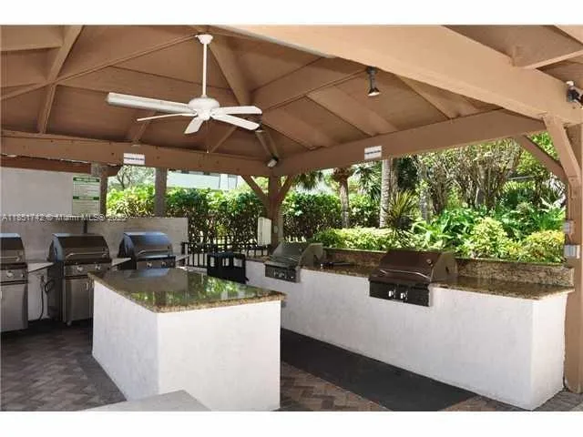 a view of a patio with table and chairs under an umbrella