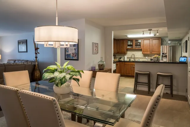 a dining room with furniture and a chandelier